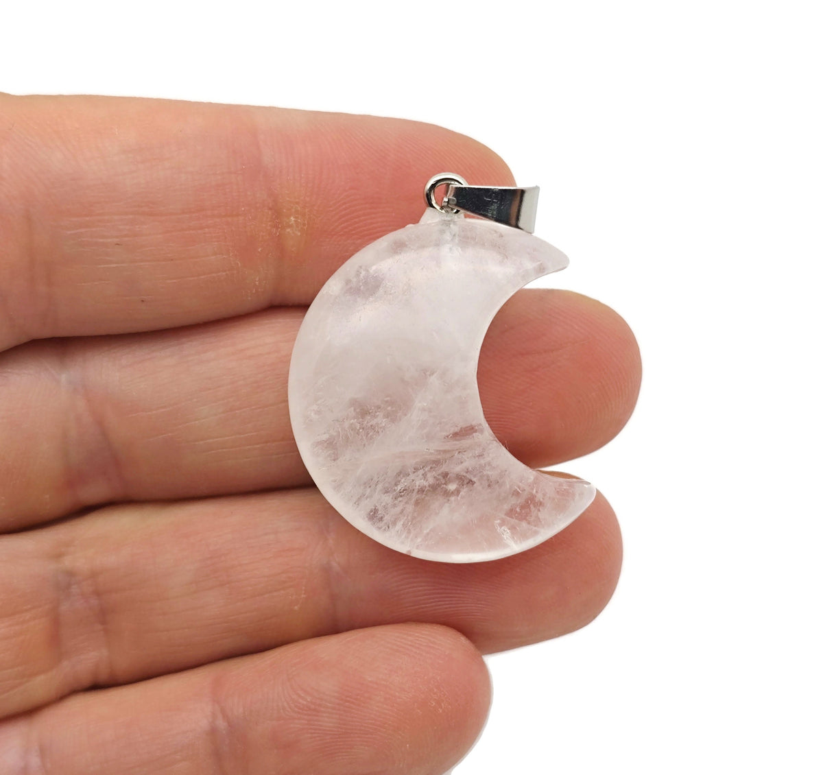 Clear quartz moon pendant featuring a crescent moon design from GemstoneGO, showcasing a polished gemstone with intricate details.