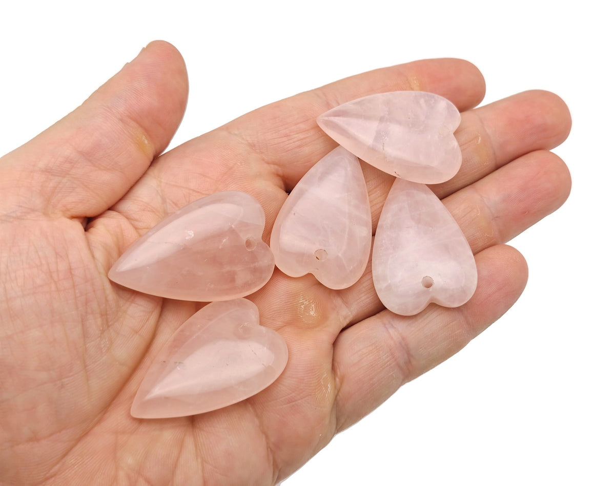 Heart-shaped rose quartz pendant from GemstoneGO, featuring a long love crystal healing gemstone with a smooth polished surface.