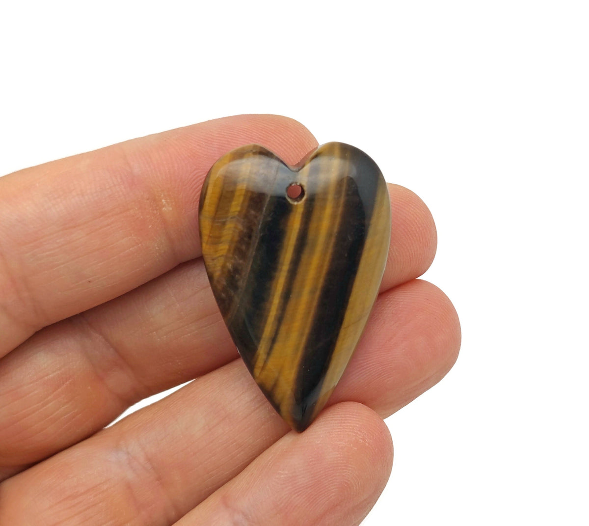 Tiger Eye long heart-shaped love crystal pendant with a polished gemstone, featuring warm brown and gold tones, on a silver chain.