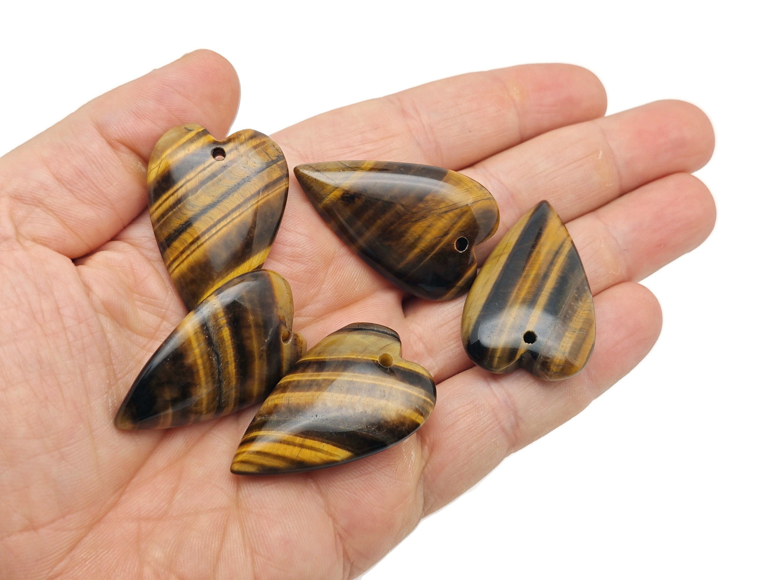 Heart-shaped Tiger Eye love crystal pendant with a polished gemstone, showcasing its warm golden-brown hues and smooth surface.