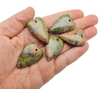 Heart-shaped Unakite crystal pendant with a silver bail, showcasing vibrant green and pink hues, perfect for healing and love jewelry.