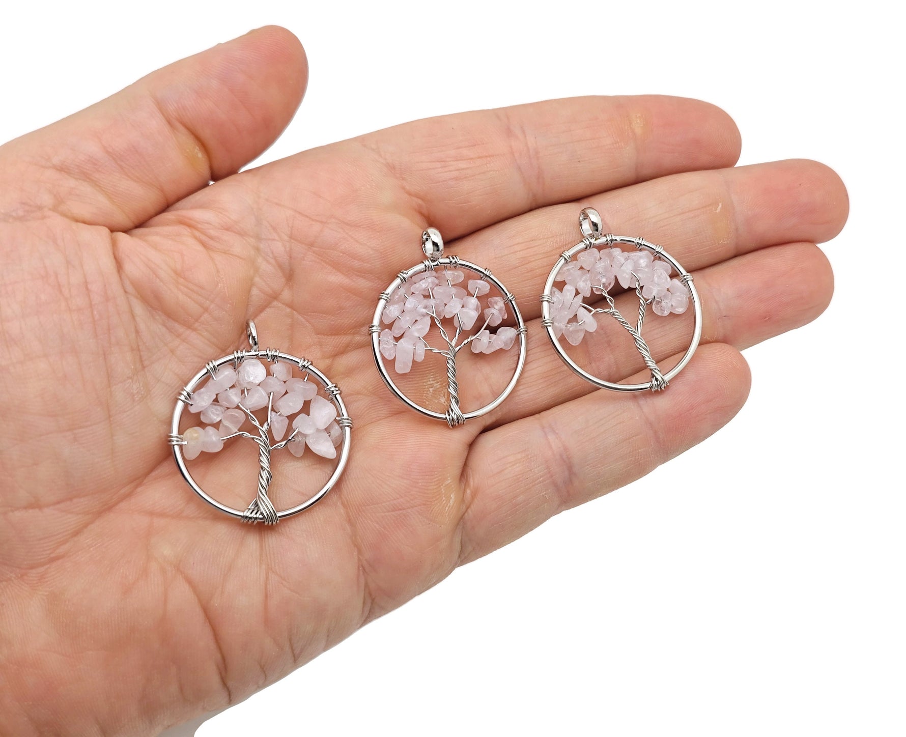 Rose quartz Tree of Life gemstone pendant by GemstoneGO featuring a detailed crystal design on a delicate chain.