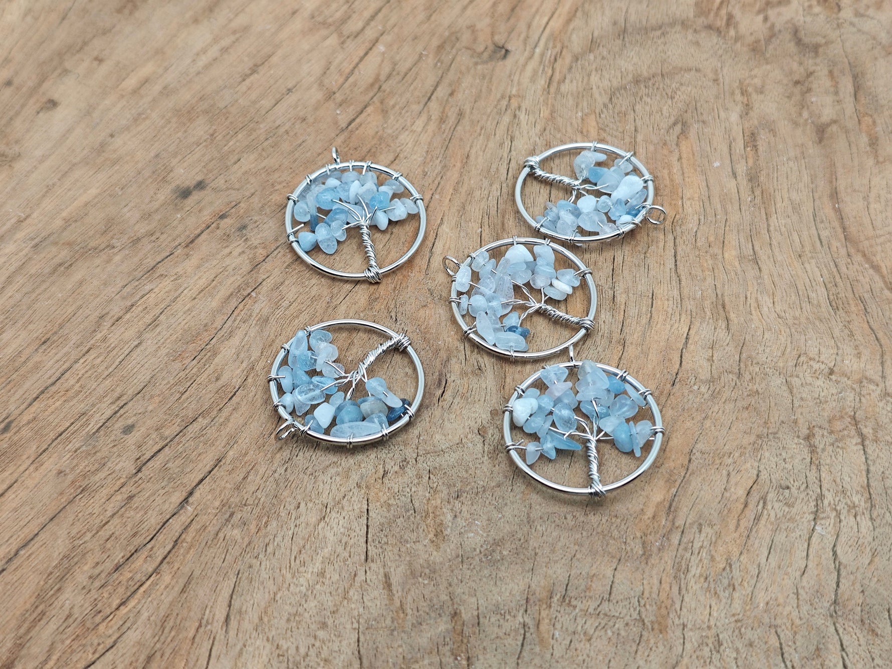 Aquamarine Tree of Life gemstone pendant from GemstoneGO, featuring intricate design and vibrant blue aquamarine gemstones.