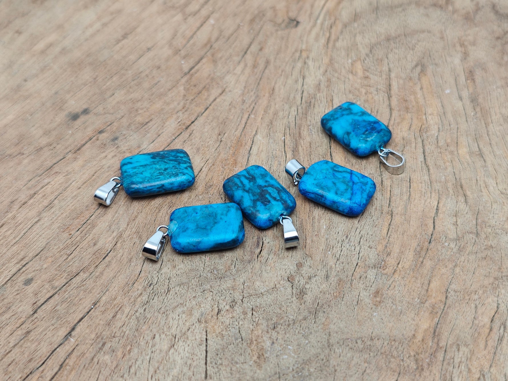 Blue Apatite rectangle-shaped crystal pendant from GemstoneGO, showcasing a vibrant blue gemstone with silver setting.