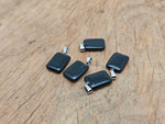 Rectangular obsidian crystal pendant from GemstoneGO, showcasing a sleek black gemstone with polished surface and natural texture.
