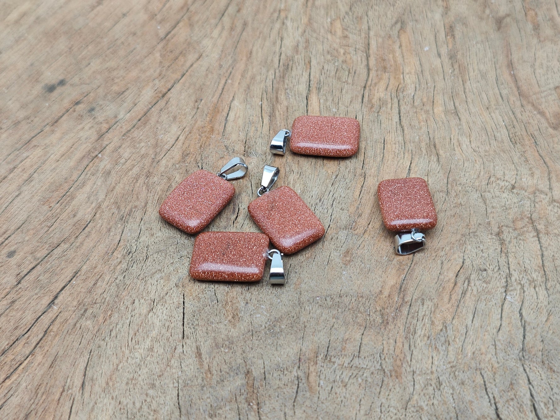 Goldstone rectangle gemstone pendant by GemstoneGO featuring a shimmering goldstone crystal in a sleek rectangular shape.