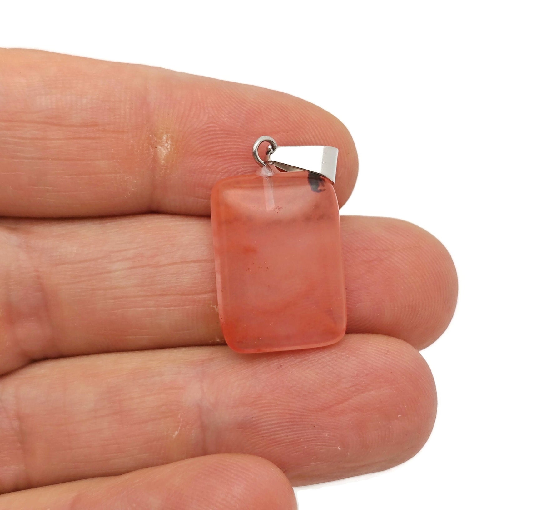 Cherry quartz rectangle crystal pendant from GemstoneGO, featuring a vibrant red gemstone set in a sleek rectangular shape.