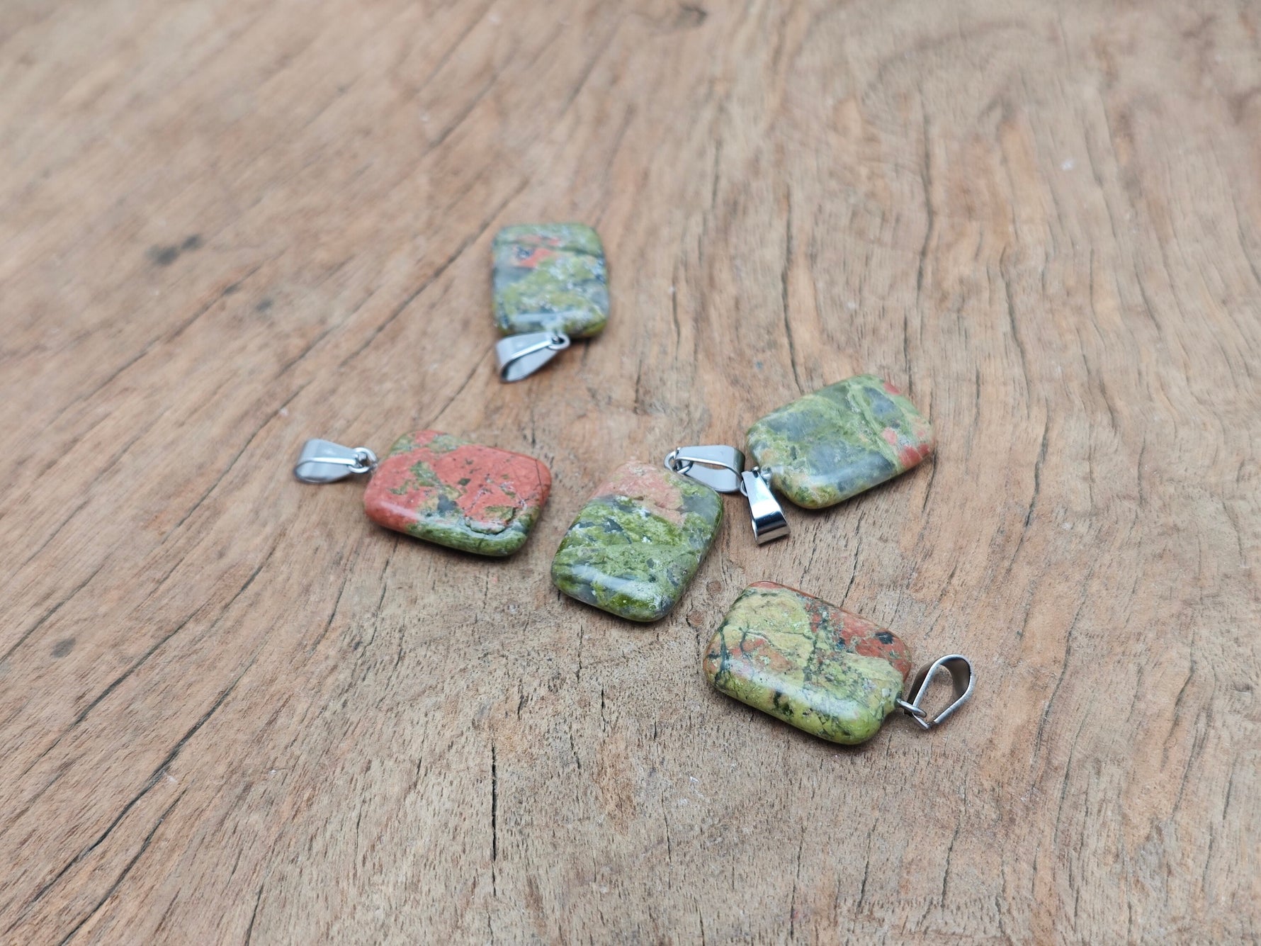 Unakite rectangle-shaped crystal pendant from GemstoneGO, showcasing vibrant green and pink hues for jewelry making.
