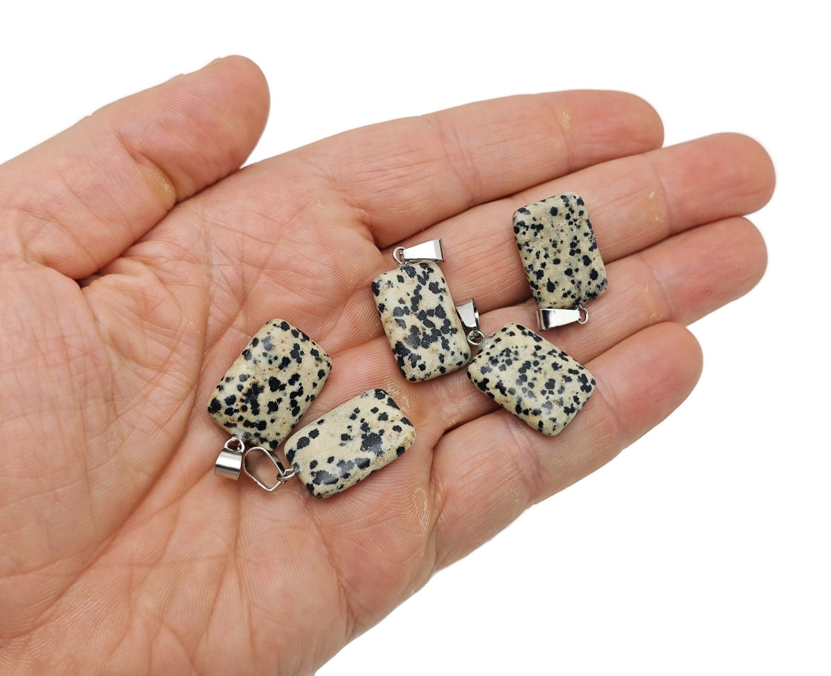 Dalmatian Jasper rectangle-shaped crystal pendant from GemstoneGO, featuring black and cream spotted pattern, wholesale gemstone jewelry.