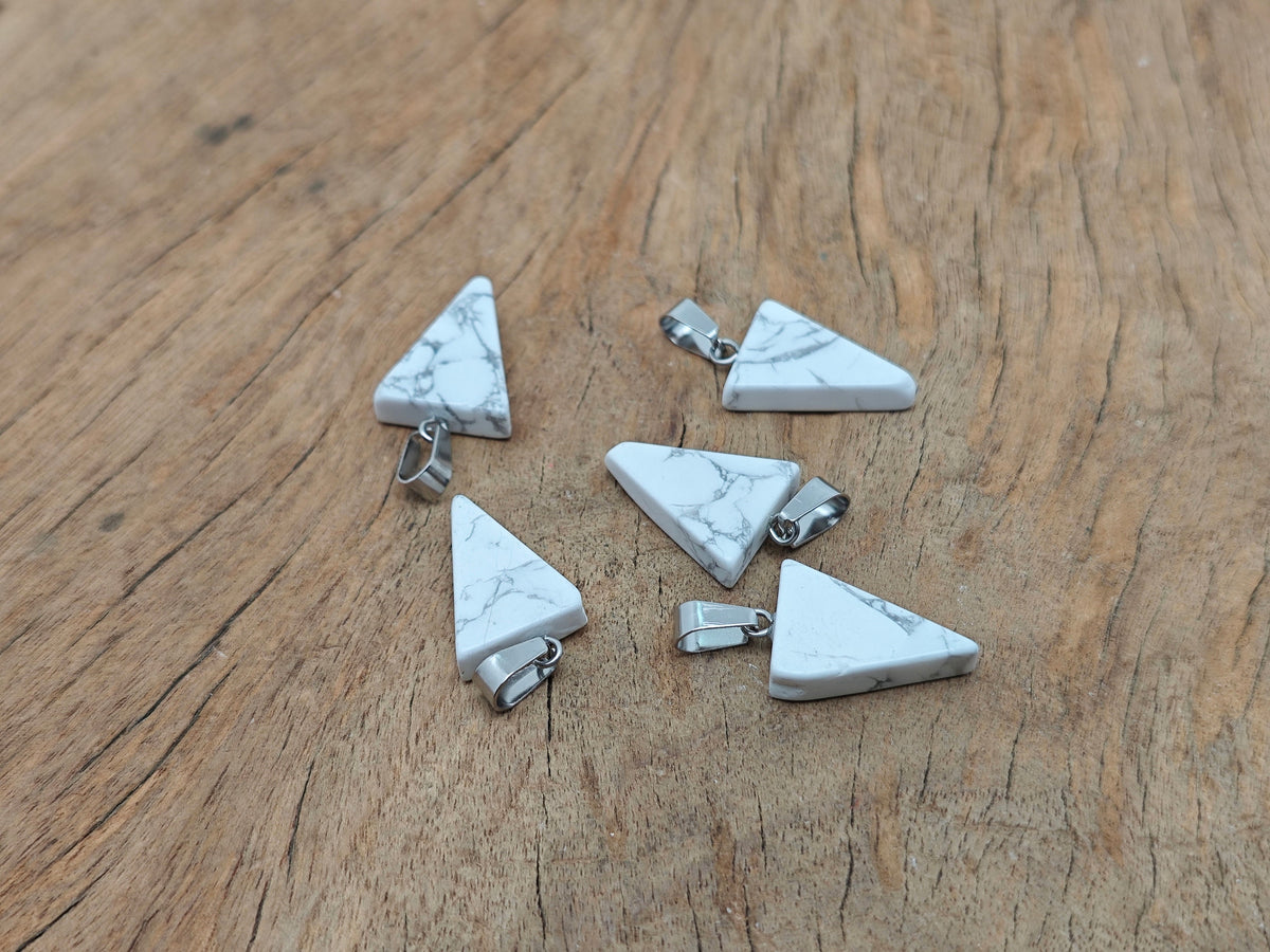 Bulk wholesale Howlite triangle-shaped crystal pendant from GemstoneGO, showcasing smooth white stone with subtle gray veining.