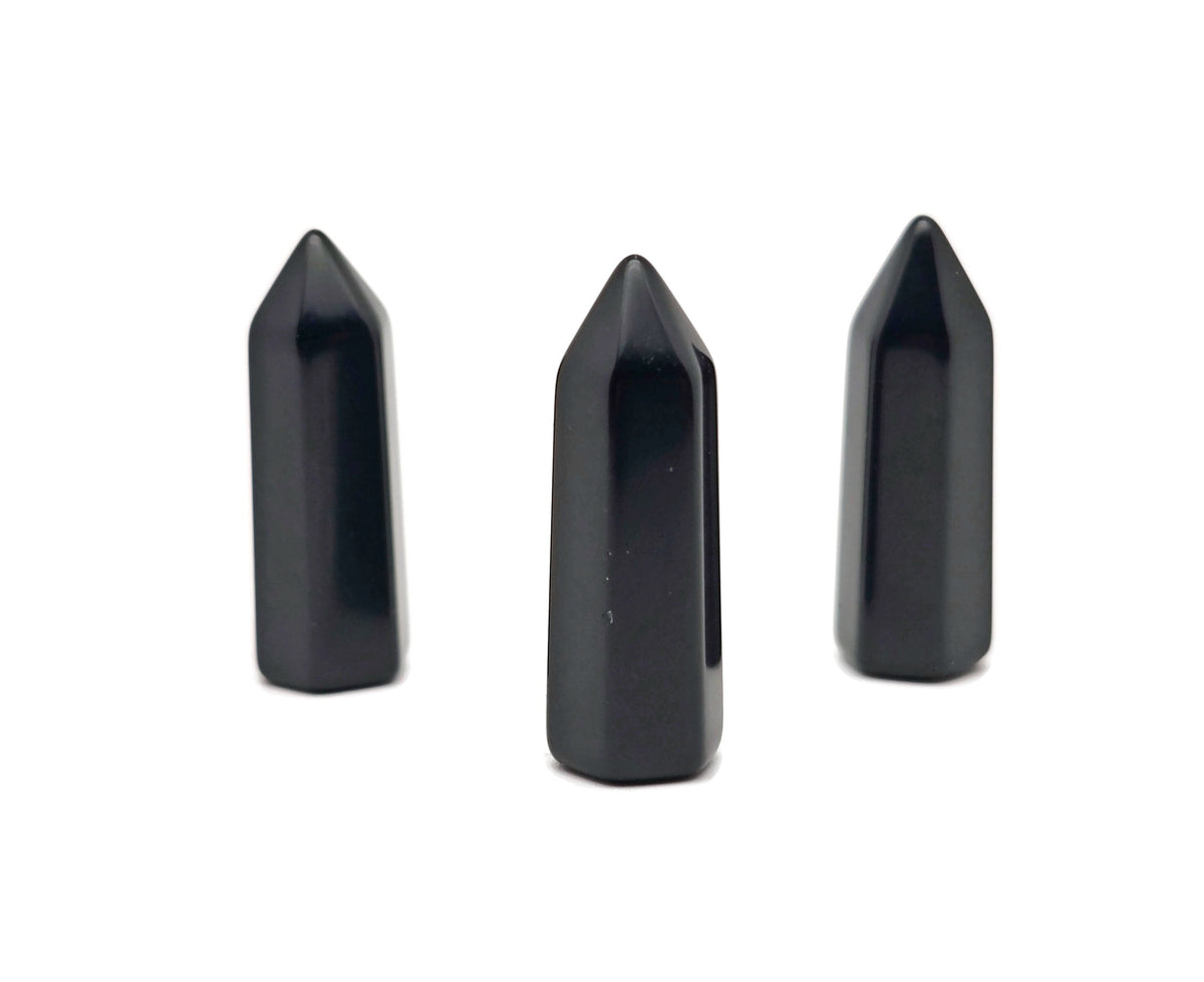Polished 40mm Obsidian Obelisk Tower crystal from GemstoneGO, with smooth black surface and pointed top, on a neutral background.