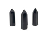 Polished 40mm Obsidian Obelisk Tower crystal from GemstoneGO, with smooth black surface and pointed top, on a neutral background.