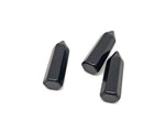 Polished 40mm black Obsidian Obelisk Tower crystal from GemstoneGO, showcasing its smooth, glossy surface and pointed shape.