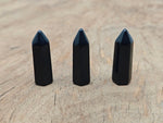 Obsidian obelisk tower crystal, 40mm, from GemstoneGO, featuring a sleek black polished stone with natural crystal details.