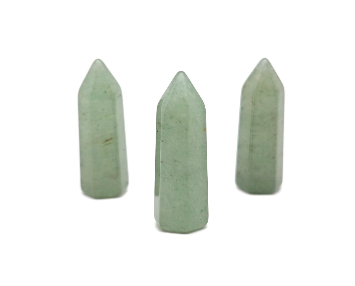 Aventurine obelisk tower crystal from GemstoneGO, 40mm tall, with green and sparkling gemstone features on a neutral background.