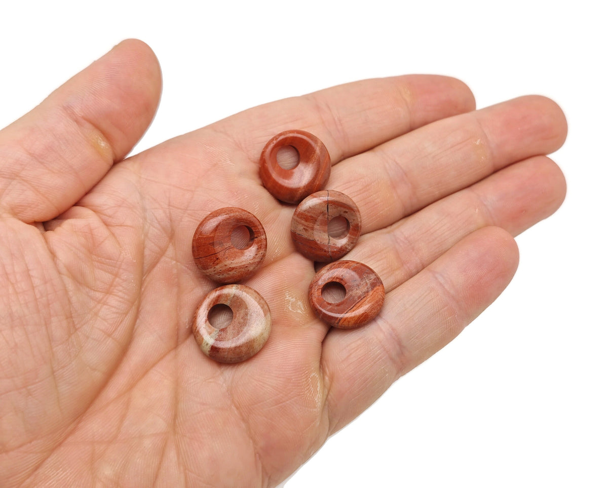 Red Jasper crystal donut pendant from GemstoneGO, 18mm Pi Stone, showcasing a polished red jasper stone with natural patterns.