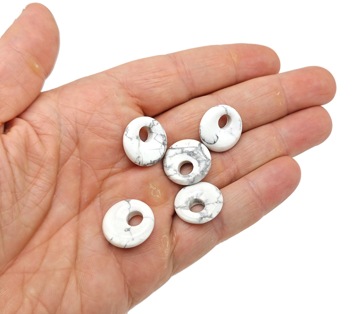 Howlite crystal donut pendant, 18mm Pi stone by GemstoneGO, featuring a smooth, polished white stone with subtle gray veining.