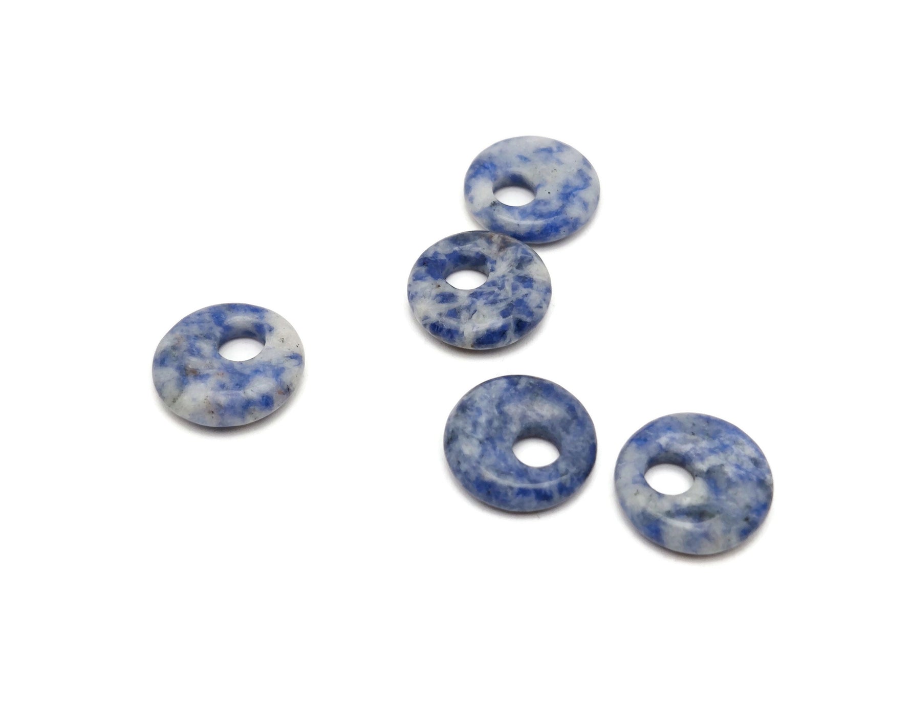 Sodalite crystal donut pendant, 18mm Pi stone from GemstoneGO, showing deep blue and white mineral patterns on polished surface.