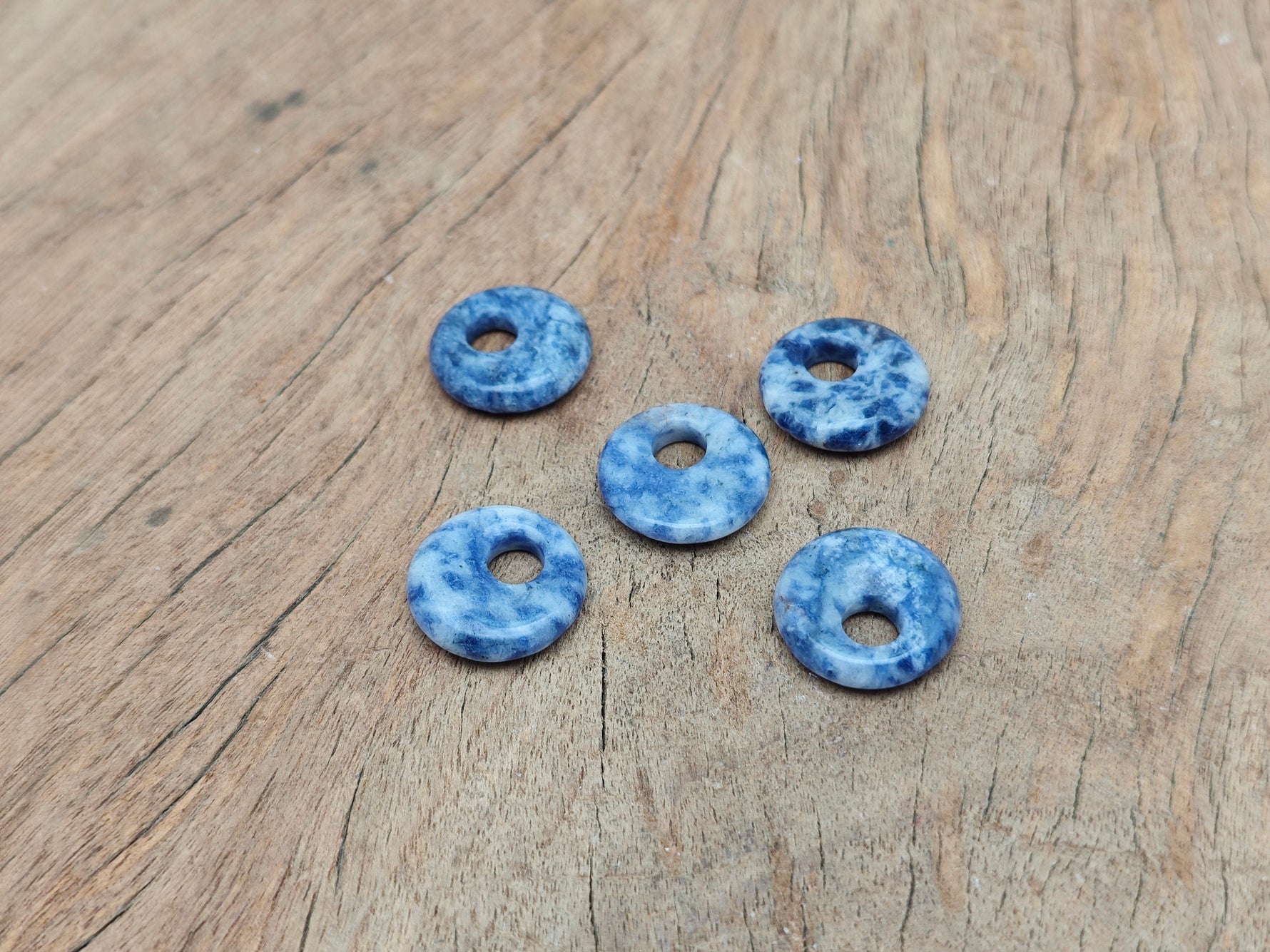 Sodalite crystal donut pendant, 18mm Pi Stone from GemstoneGO, showcasing deep blue and white natural mineral patterns.