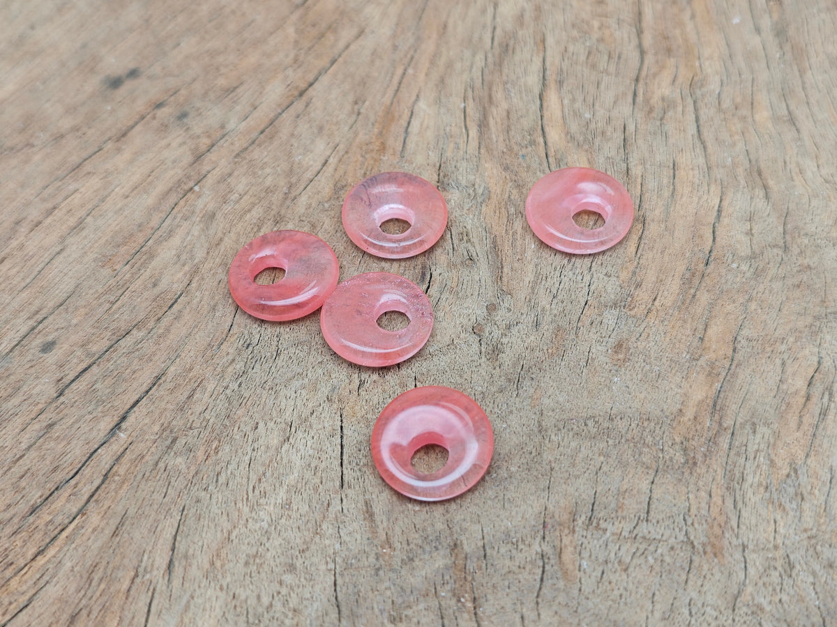 Cherry quartz crystal donut pendant from GemstoneGO, 18mm Pi stone with vibrant red color and smooth, polished surface.