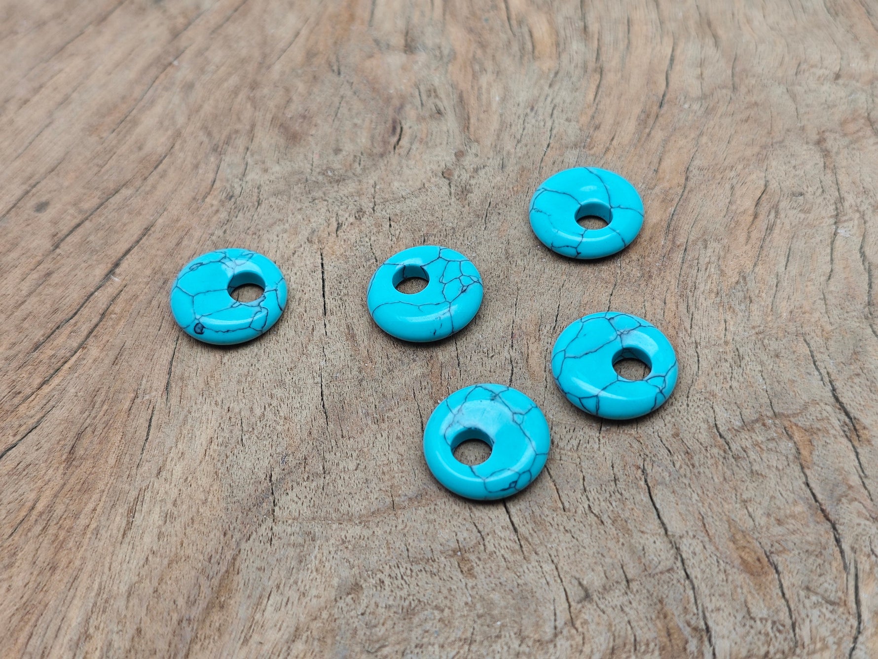 Turquoise crystal donut pendant with a Pi stone design, 18mm size, from GemstoneGO, showing detailed polished gemstone surface.