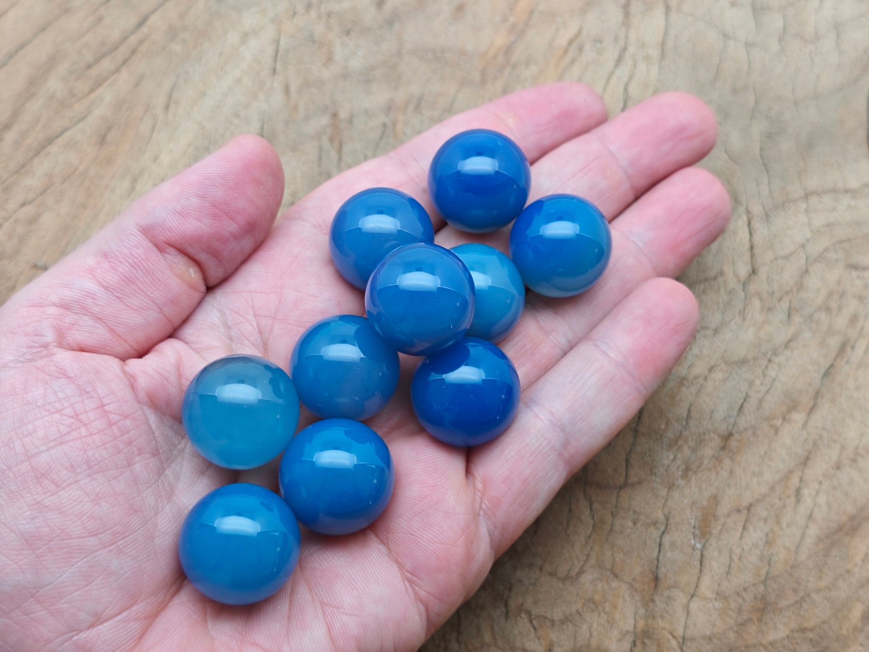 Blue agate gemstone sphere, 20mm crystal ball from GemstoneGO, smooth polished blue stone with natural banding and vibrant color.