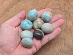 Caribbean Calcite tumbled stone from GemstoneGO, smooth orange and yellow mineral with vibrant natural patterns.