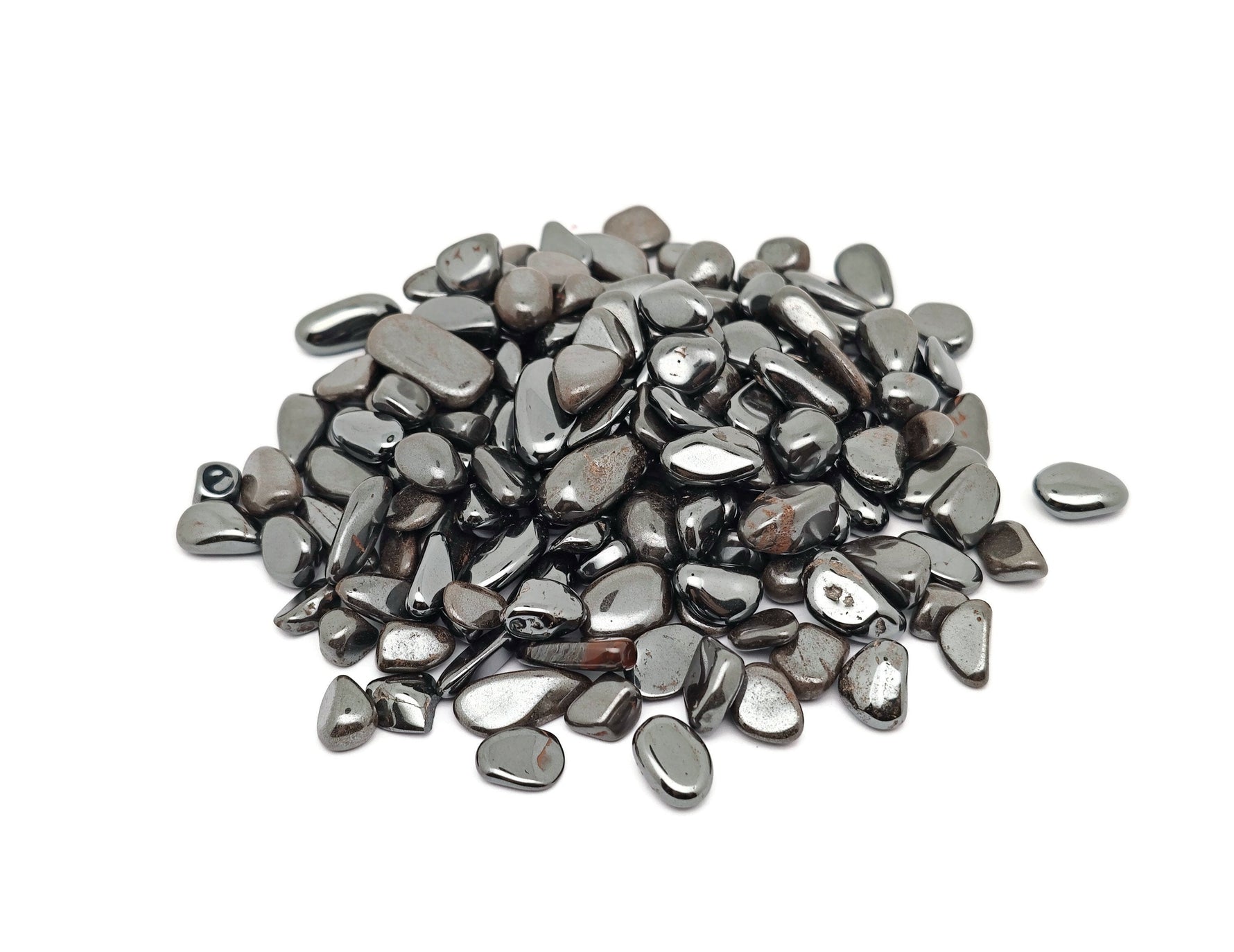 Semi-tumbled hematite crystal chips, 7-12mm, from GemstoneGO, shown in a close-up image of dark metallic stone chips.