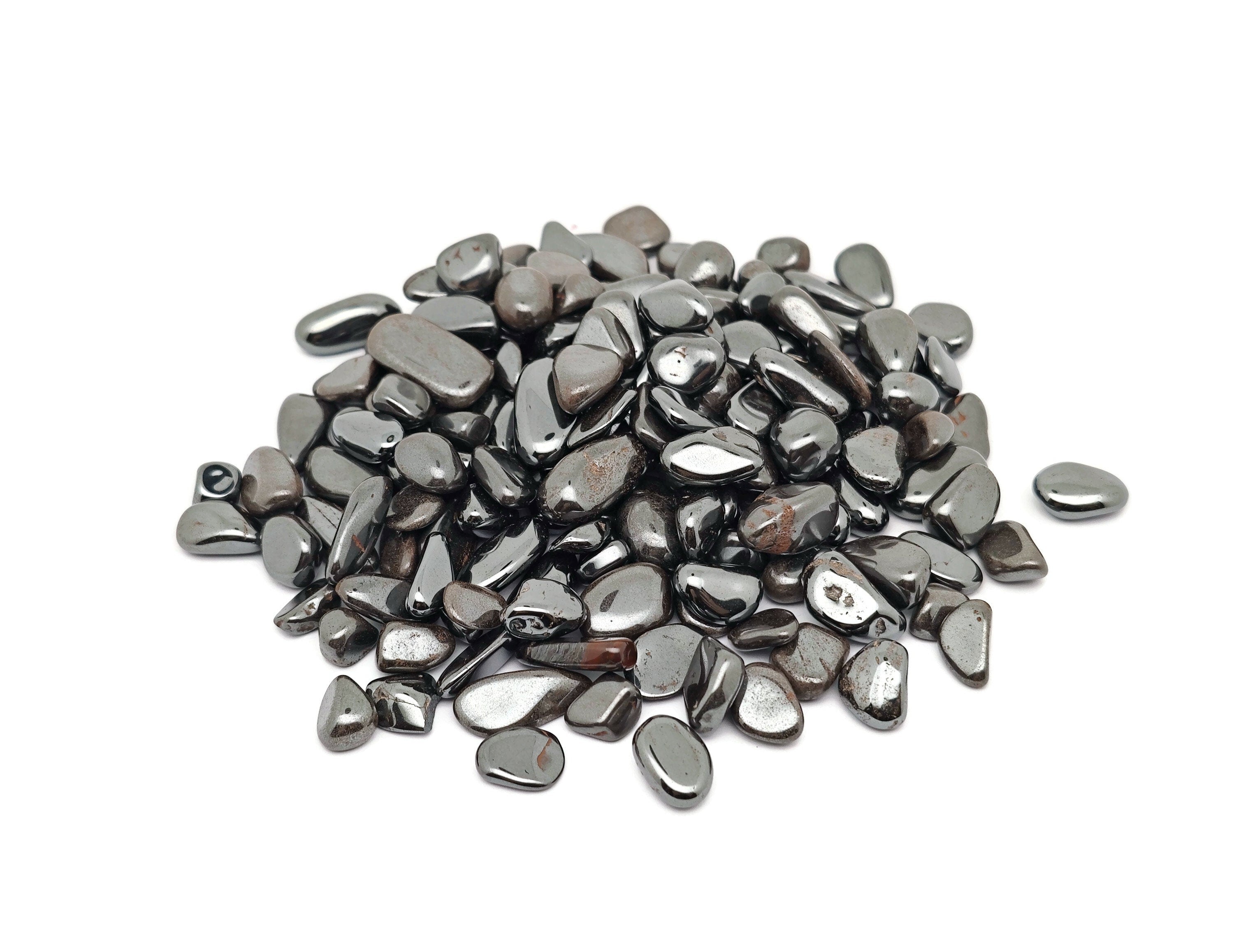 Semi-tumbled hematite crystal chips, 7-12mm, from GemstoneGO, shown in a close-up image of dark metallic stone chips.