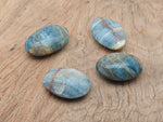 Blue Onyx palm gemstone spa stone from GemstoneGO, showing smooth, polished blue onyx with natural gemstone veins and rounded shape.