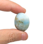 Caribbean Calcite tumbled stone by GemstoneGO showing smooth, polished blue and white mineral surface.