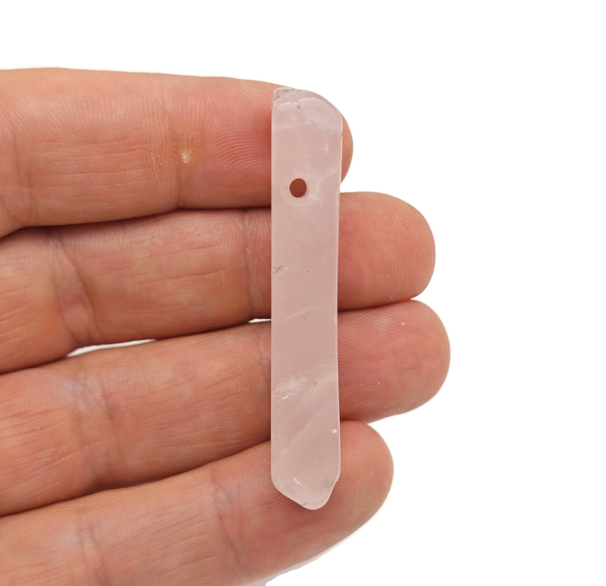 Rose Quartz drilled tumbled gemstone pendant from GemstoneGO, featuring a smooth, polished pink stone with a drilled hole for jewelry making.