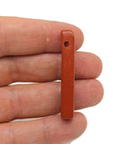 Red Jasper drilled tumbled gemstone pendant by GemstoneGO, showcasing a smooth, polished red Jasper stone with drilled hole for jewelry.