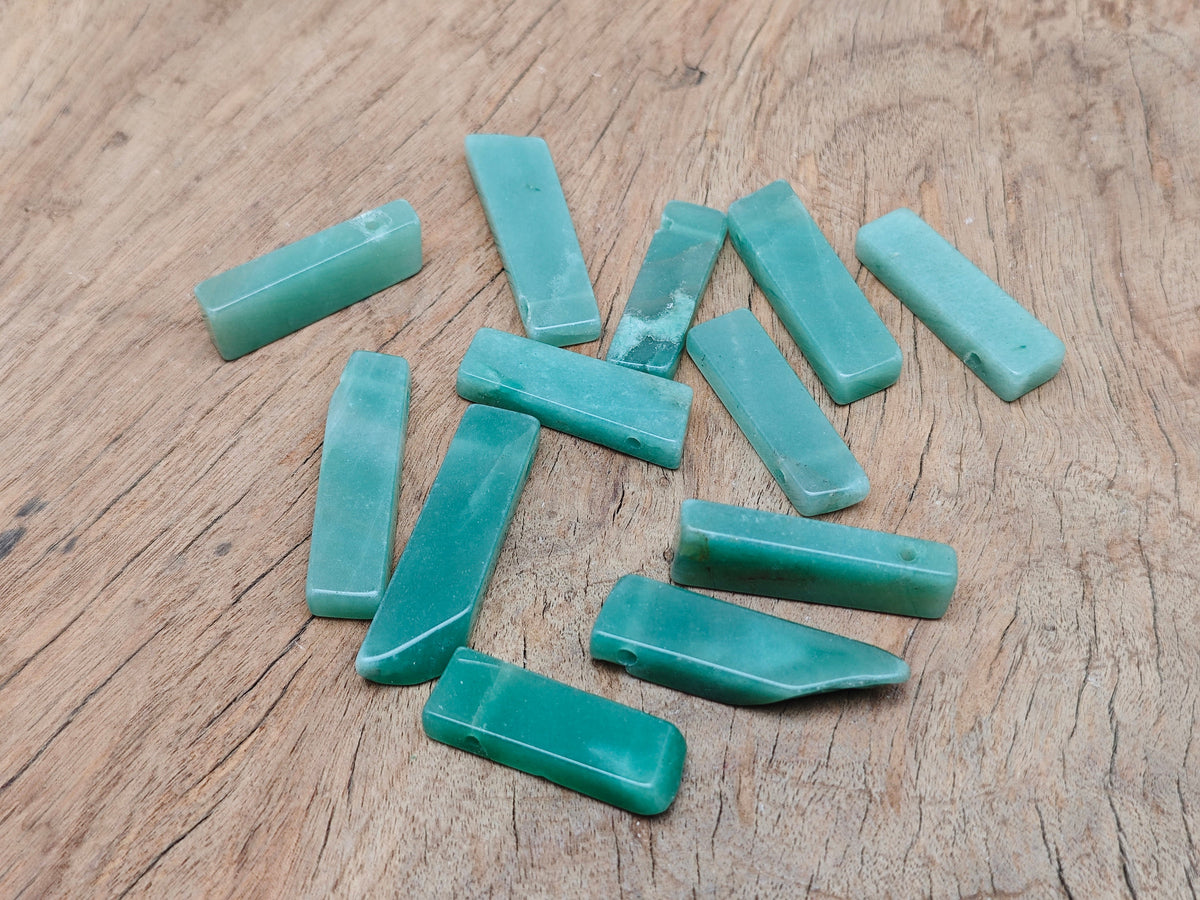 Aventurine drilled tumbled gemstone pendant from GemstoneGO showing a smooth green stone with drilled hole for jewelry.