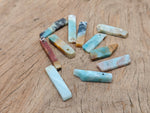 Caribbean Calcite drilled tumbled gemstone pendant from GemstoneGO, showcasing a vibrant, polished stone with drilled hole for jewelry.