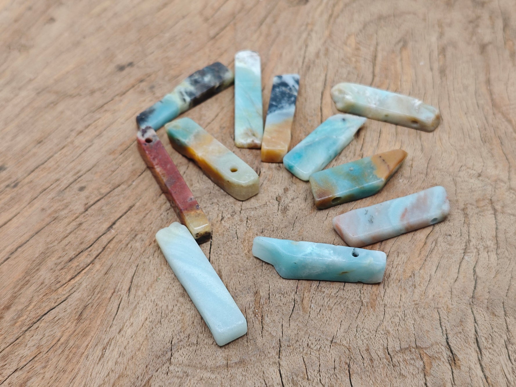 Caribbean Calcite drilled tumbled gemstone pendant from GemstoneGO, showcasing a vibrant, polished stone with drilled hole for jewelry.