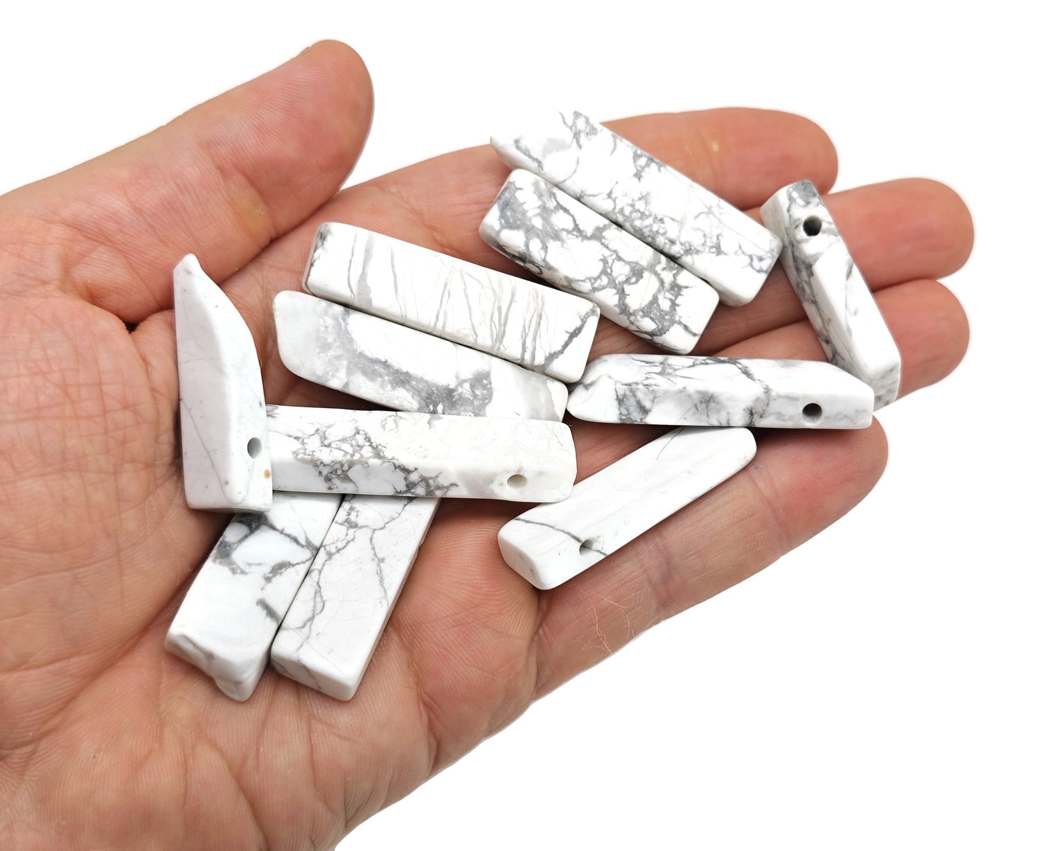 Howlite drilled tumbled gemstone pendant from GemstoneGO, showcasing a smooth, polished white stone with natural gray veining.
