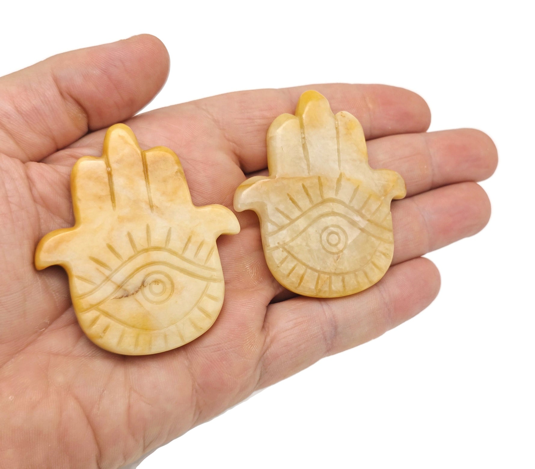 Evil Eye hand gemstone carving, pocket crystal for chakra healing and meditation, featuring colorful mixed crystals.