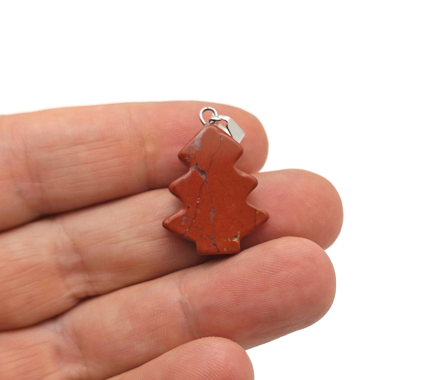 Red Jasper pine tree gemstone pendant featuring a mini crystal pendant with a natural red jasper stone and intricate tree design.