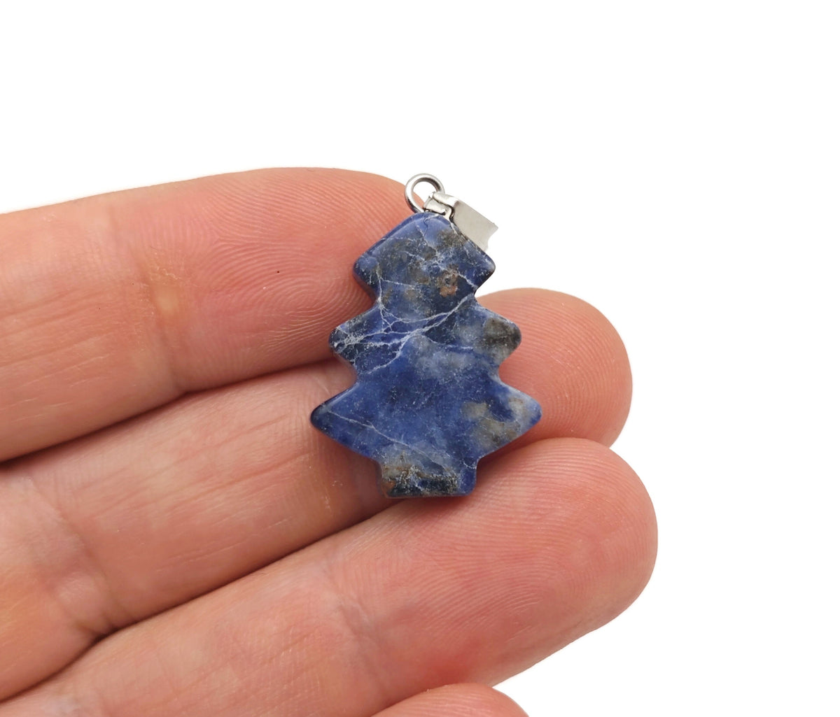Mini sodalite gemstone pendant featuring a pine tree design, crafted by GemstoneGO, showcasing blue and white mineral details.
