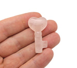 Pink rose quartz key gemstone carving, 40mm, by GemstoneGO, showcasing a detailed carved key shape in smooth, polished stone.