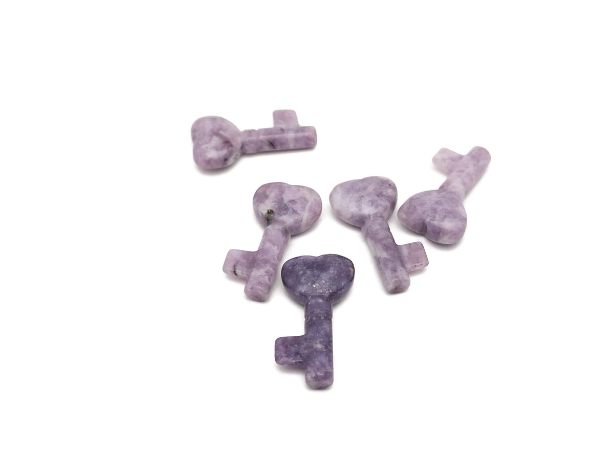 Lepidolite key gemstone carving, 40mm, from GemstoneGO, showing detailed purple and lilac hues with smooth polished surface.