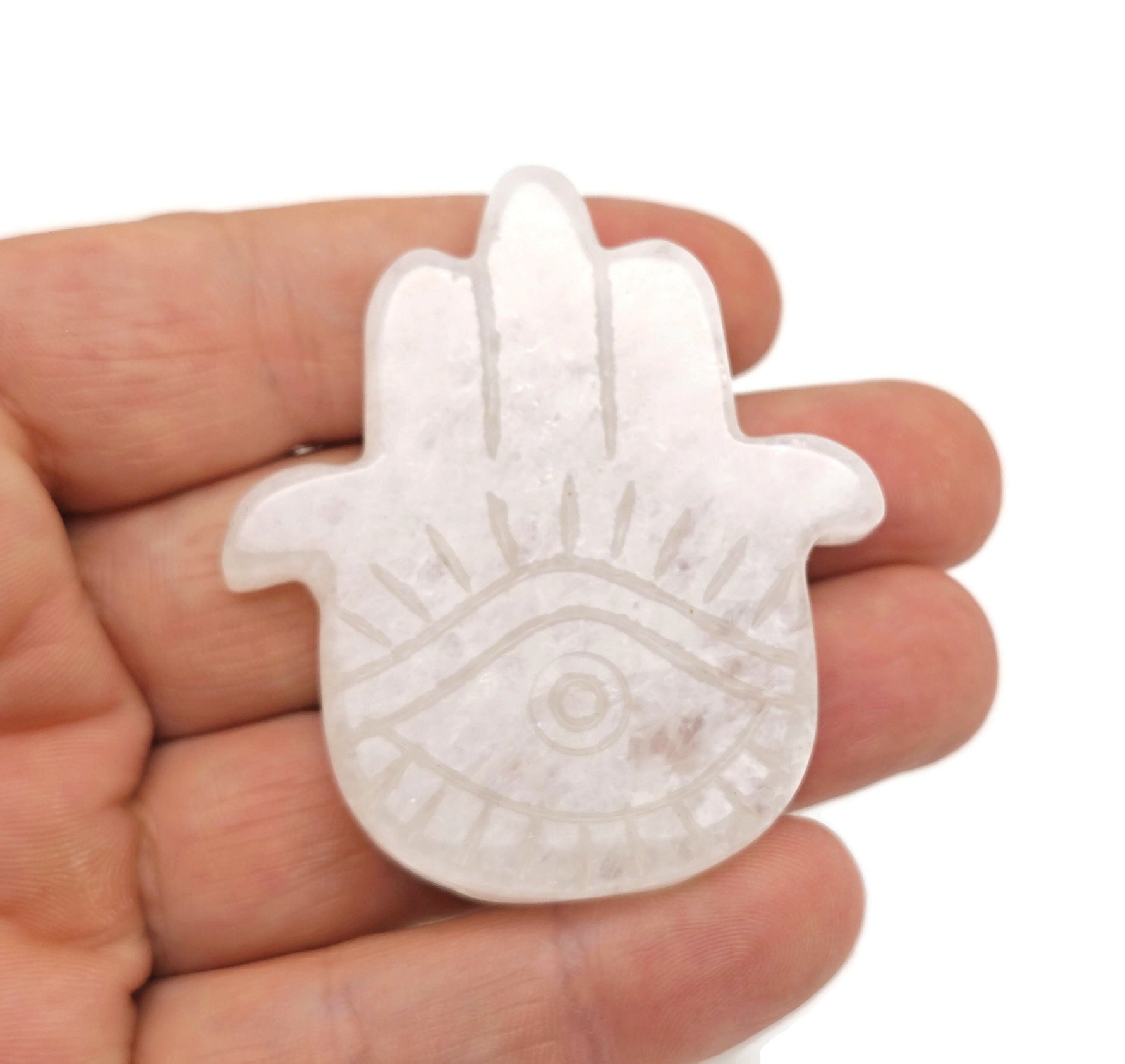 Clear quartz evil eye gemstone carving with detailed hand craftsmanship, showcasing protective amulet design by GemstoneGO.