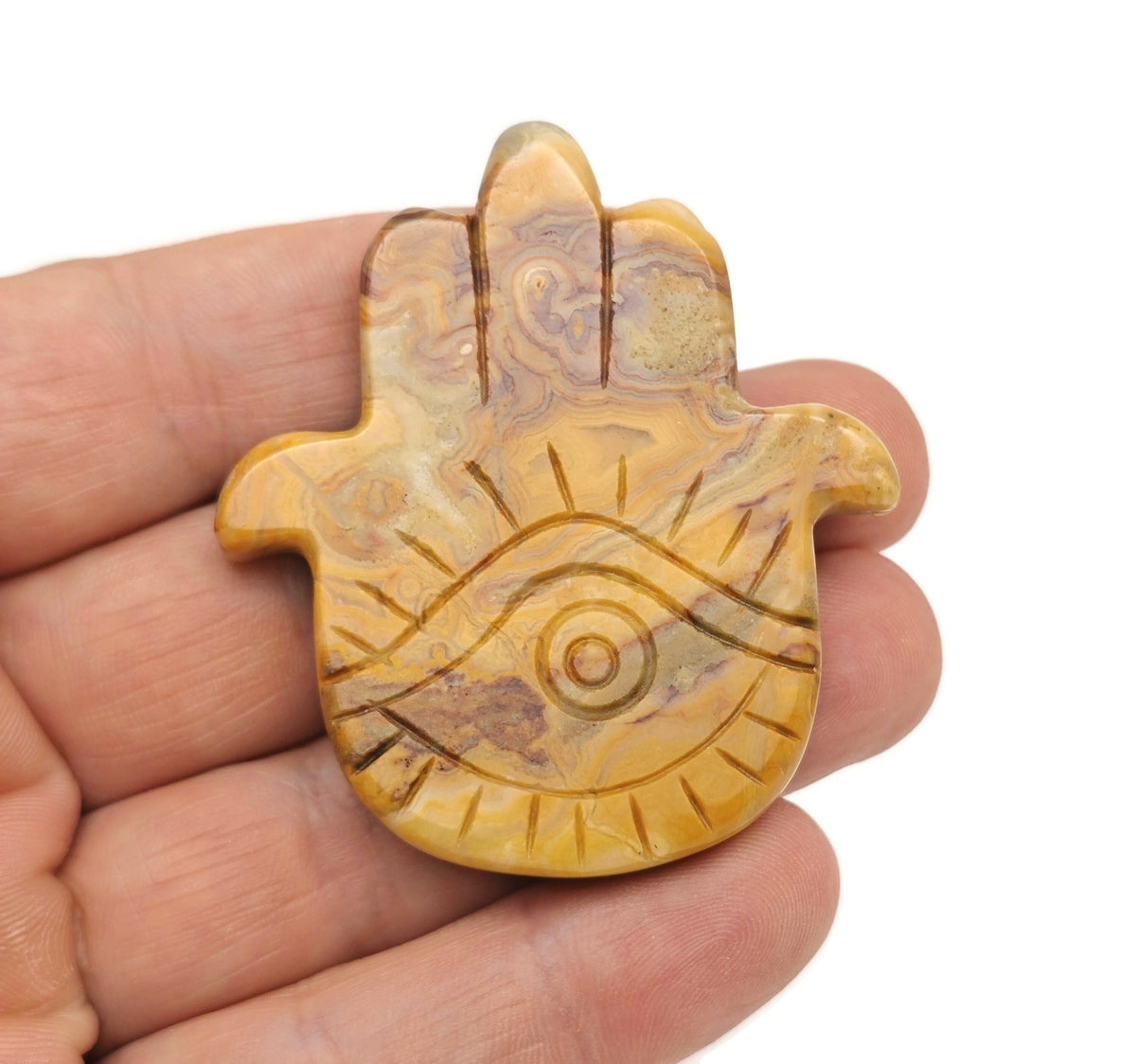 Crazy Lace Agate evil eye hand gemstone carving by GemstoneGO showing intricate details and vibrant colors on a polished stone
