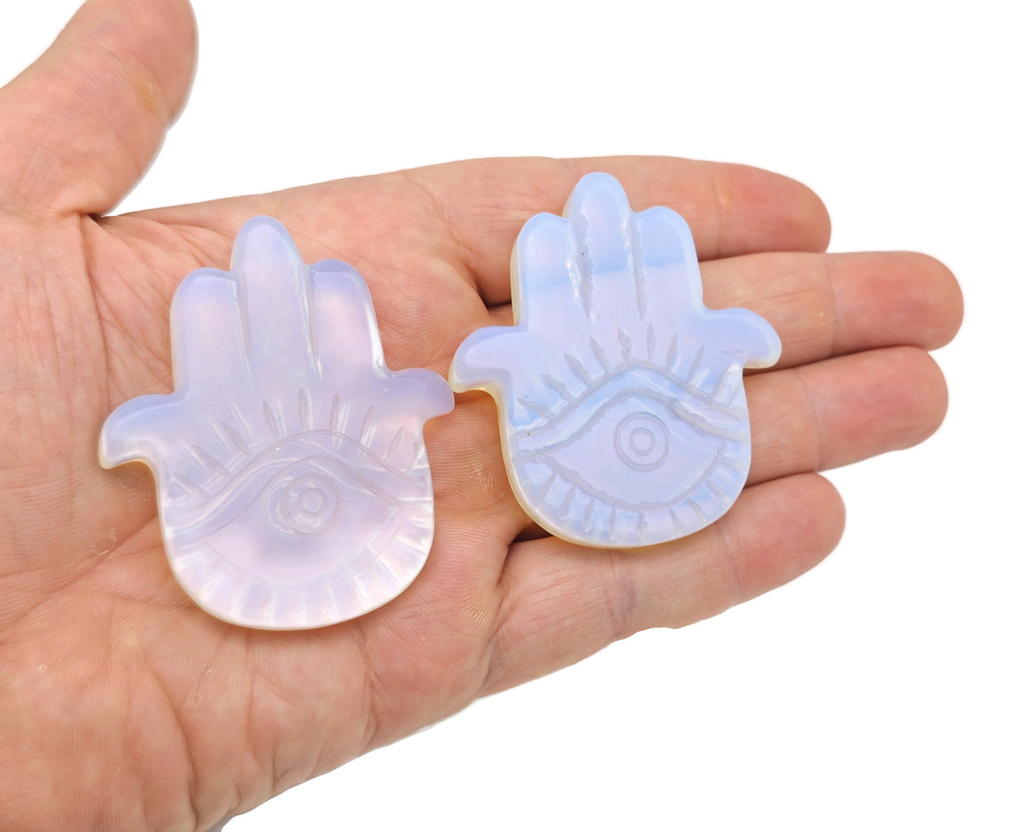 Opalite evil eye gemstone carving with hand-carved evil eye design, showcasing vibrant colors and intricate details from GemstoneGO.