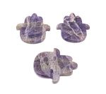 Amethyst evil eye hand gemstone carving with intricate details, showcasing vibrant purple amethyst and protective symbolism.