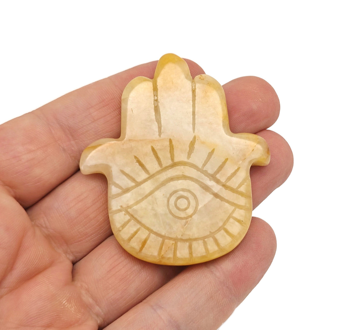 Yellow jade evil eye hand gemstone carving with detailed craftsmanship, showcasing vibrant yellow jade and intricate design.