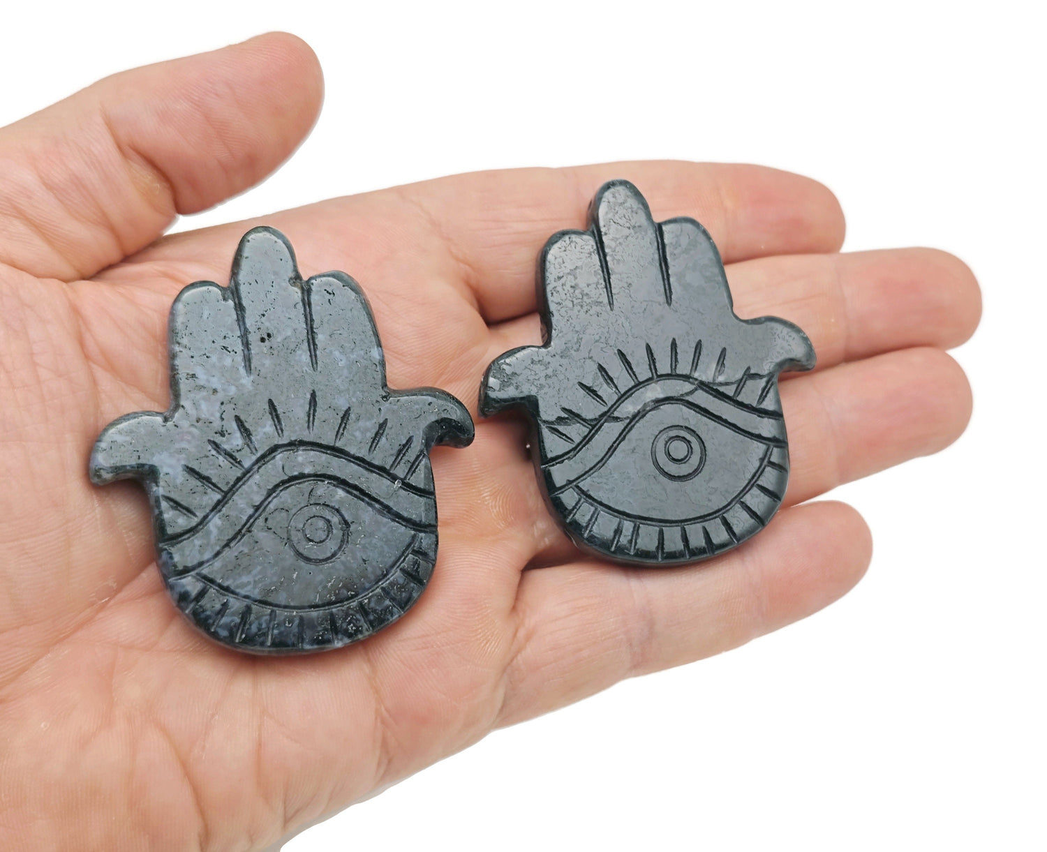 Moss agate evil eye hand gemstone carving with intricate details, crafted by GemstoneGO, showcasing natural stone patterns.