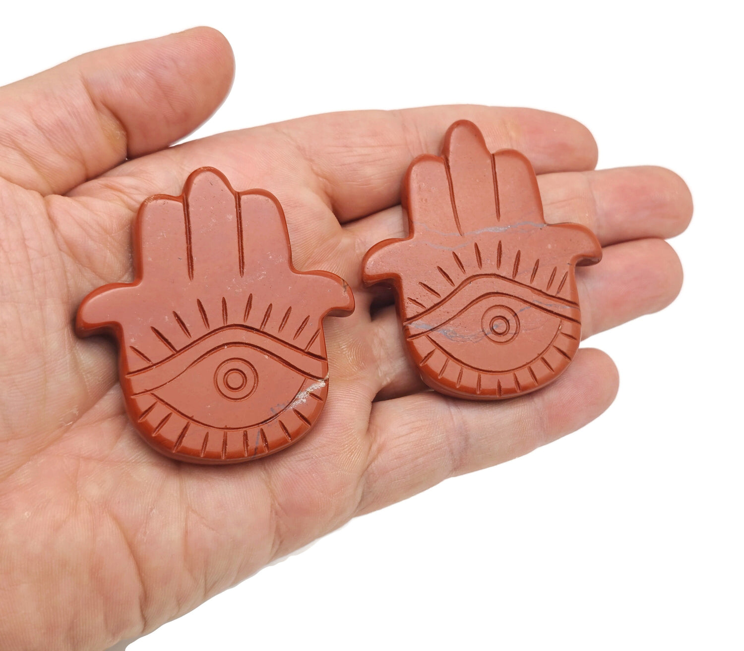Red Jasper Evil Eye gemstone carving, hand-shaped talisman with intricate details, crafted by GemstoneGO.