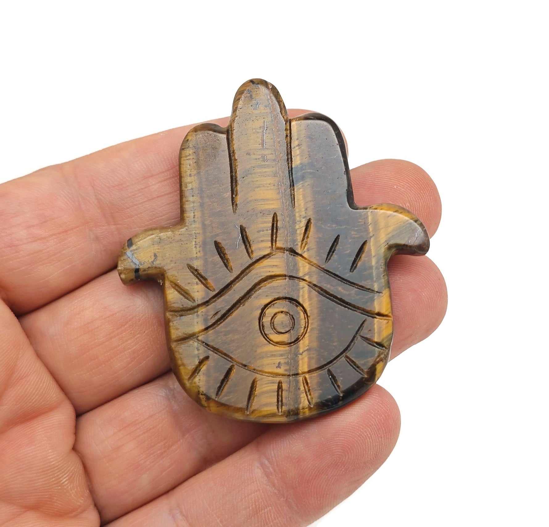 Tiger Eye evil eye gemstone carving featuring a hand-shaped design from GemstoneGO, showcasing intricate craftsmanship and vibrant colors.